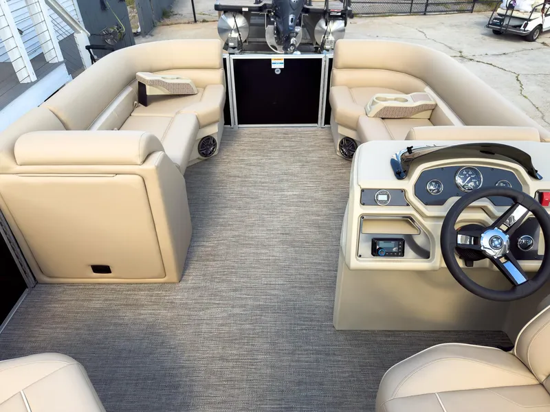 Slide: The Image of 2025 Godfrey Sweetwater Xperience 22' Tritoon interior with beige seating and modern helm. - 18
