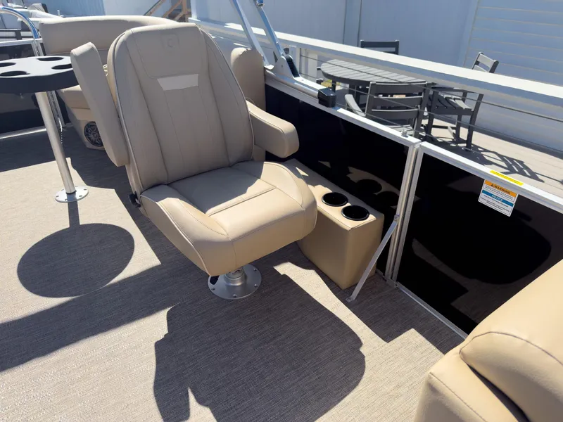 Slide: The Image of 2025 Godfrey Sweetwater Xperience 22' Tritoon with beige seating and cup holders. - 19