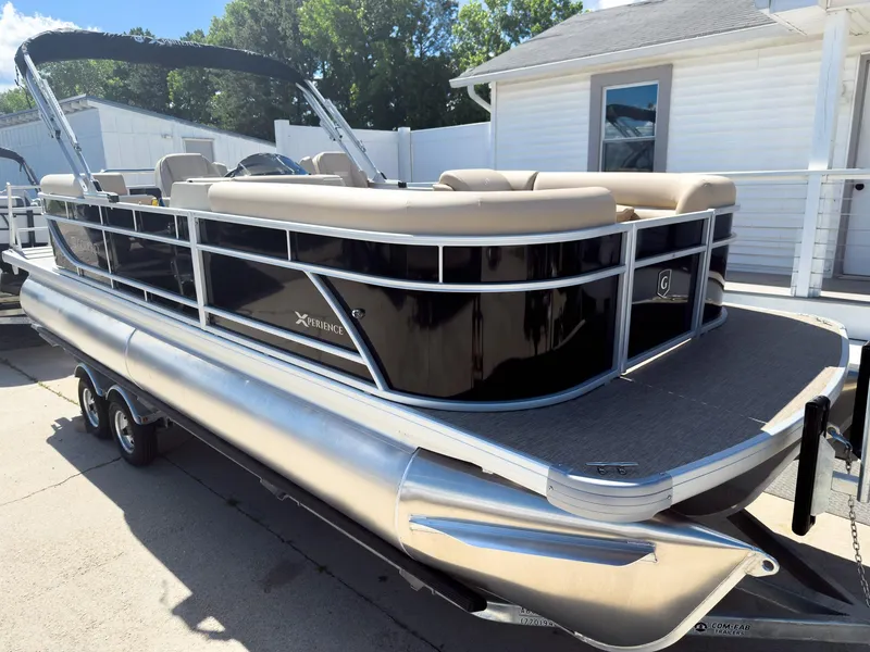 Slide: The Image of 2025 Godfrey Sweetwater Xperience 22' Tritoon with split bench, docked outdoors. - 2