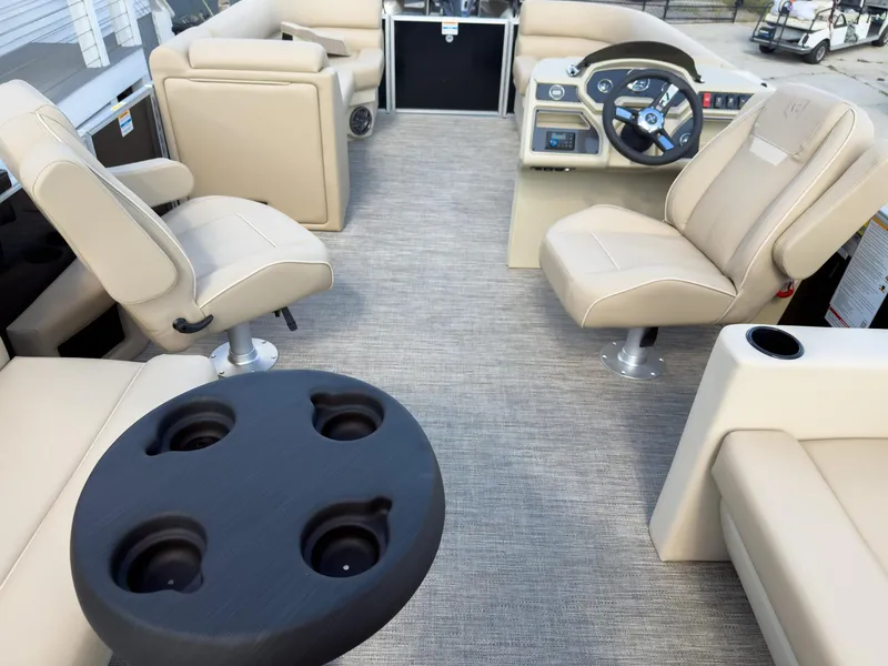 Slide: The Image of Interior of 2025 Godfrey Sweetwater Xperience 22' Tritoon with beige seating and steering console. - 20