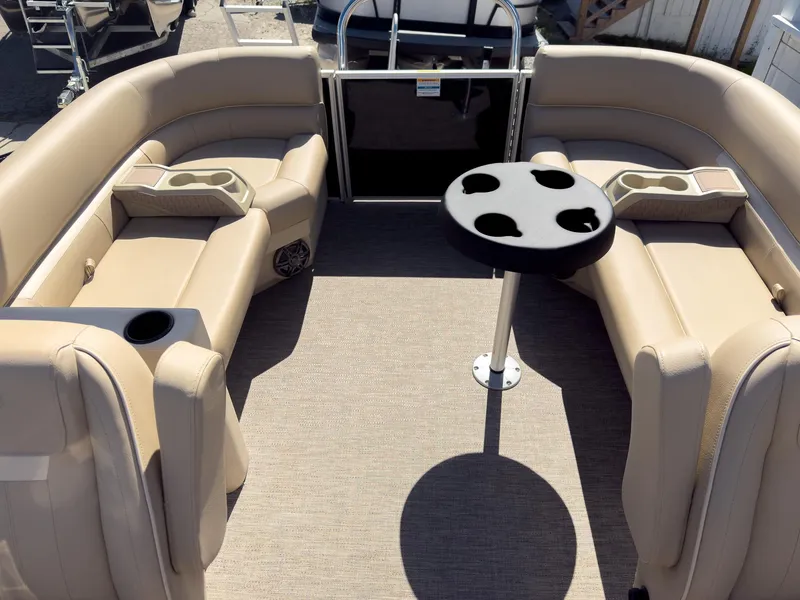Slide: The Image of 2025 Godfrey Sweetwater Xperience 22' Tritoon interior with beige seating and table. - 22
