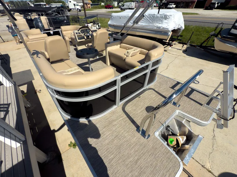 Slide: The Image of 2025 Godfrey Sweetwater Xperience 22' Tritoon with split bench seating, docked outdoors. - 26