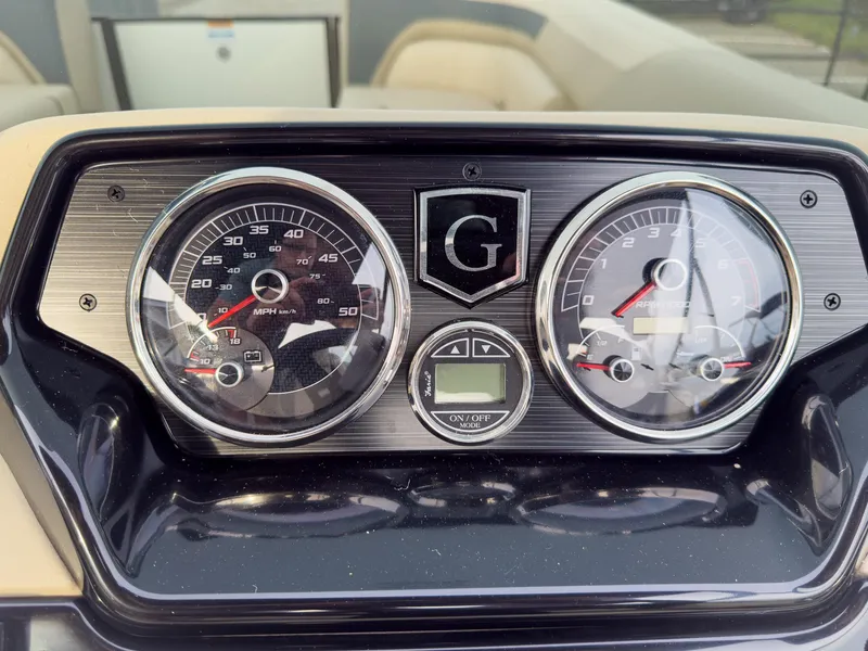 Slide: The Image of Dashboard of 2025 Godfrey Sweetwater 22' Flip Lounge Tritoon, featuring speedometer and gauges. - 15