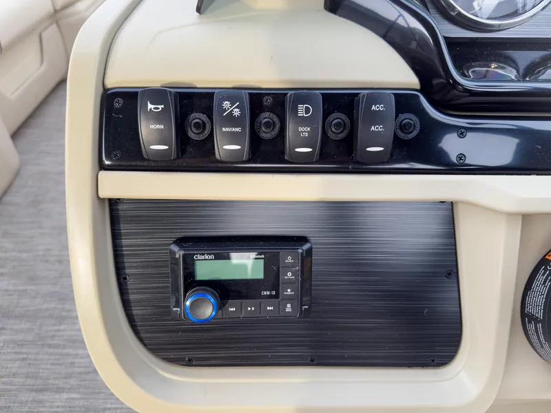 Slide: The Image of Control panel of 2025 Godfrey Sweetwater 22' Flip Lounge Tritoon with switches and Clarion audio system. - 16