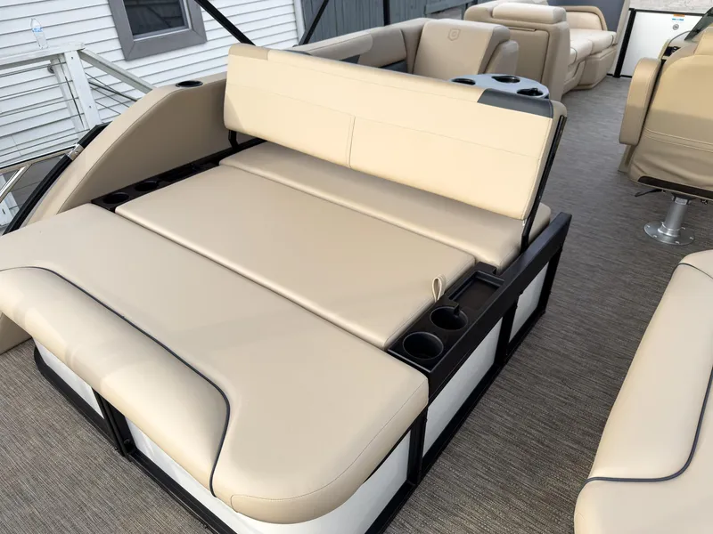Slide: The Image of 2025 Godfrey Sweetwater 22' Tritoon with beige flip lounge seating and cup holders. - 21