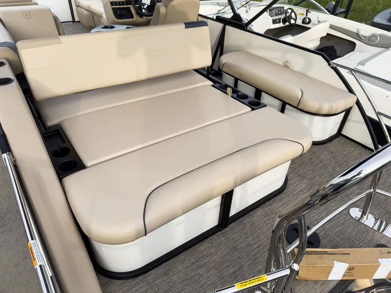 Slide: The Image of 2025 Godfrey Sweetwater 22' Tritoon with beige flip lounge seating and modern interior design. - 23