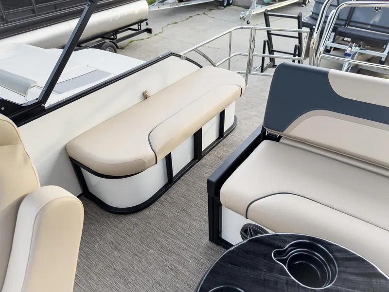 Slide: The Image of Interior of 2025 Godfrey Sweetwater 22' Tritoon with beige seating and cup holders. - 26