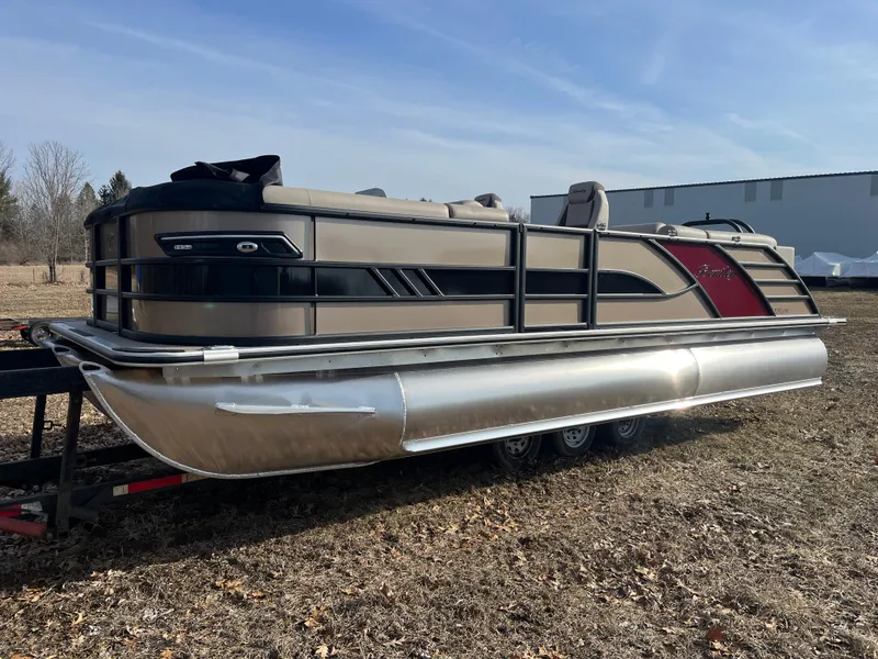 The Image of 2025 Bentley Pontoons 223 Elite Admiral on a trailer, outdoors under clear sky. - 1