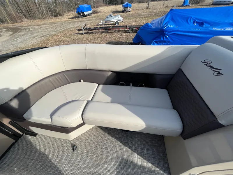 Slide: The Image of 2025 Bentley Pontoons 223 Elite Admiral interior seating with beige and brown upholstery. - 11