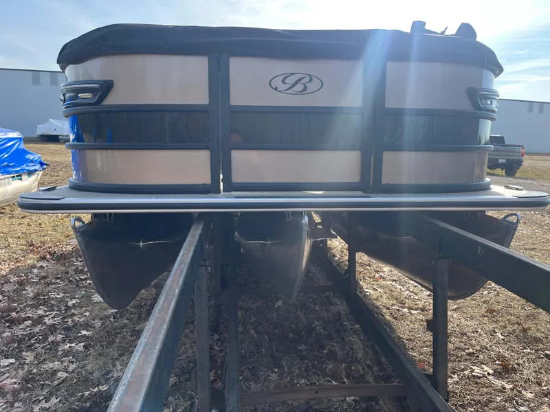 Slide: The Image of 2025 Bentley Pontoons 223 Elite Admiral on trailer, front view, outdoor setting. - 15