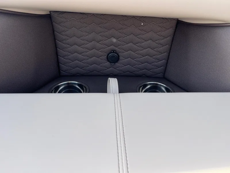 Slide: The Image of 2025 Bentley Pontoons 223 Elite Admiral interior with cup holders and quilted upholstery. - 21