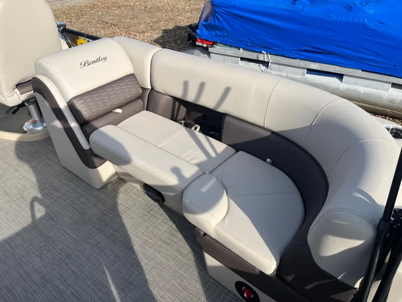 Slide: The Image of 2025 Bentley Pontoons 223 Elite Admiral, luxurious seating, beige and brown upholstery, outdoor setting. - 23
