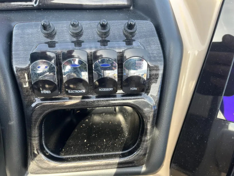 Slide: The Image of Control panel of 2025 Bentley Pontoons 223 ELITE ADMIRAL with labeled switches for stereo, electronics, accessory, and horn. - 26