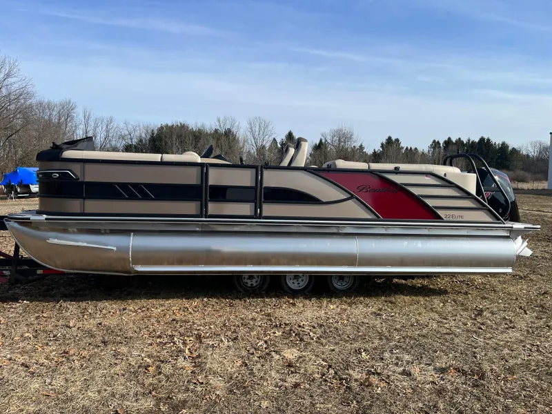 Slide: The Image of 2025 Bentley Pontoons 223 ELITE ADMIRAL on grassy field, showcasing sleek design and luxury features. - 3