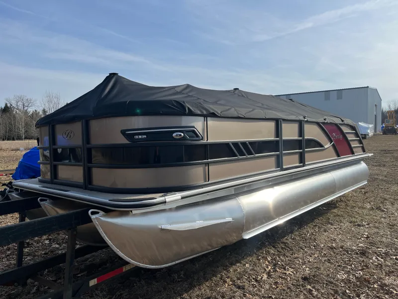 Slide: The Image of 2025 Bentley Pontoons 223 Elite Admiral pontoon boat with cover, parked outdoors. - 31