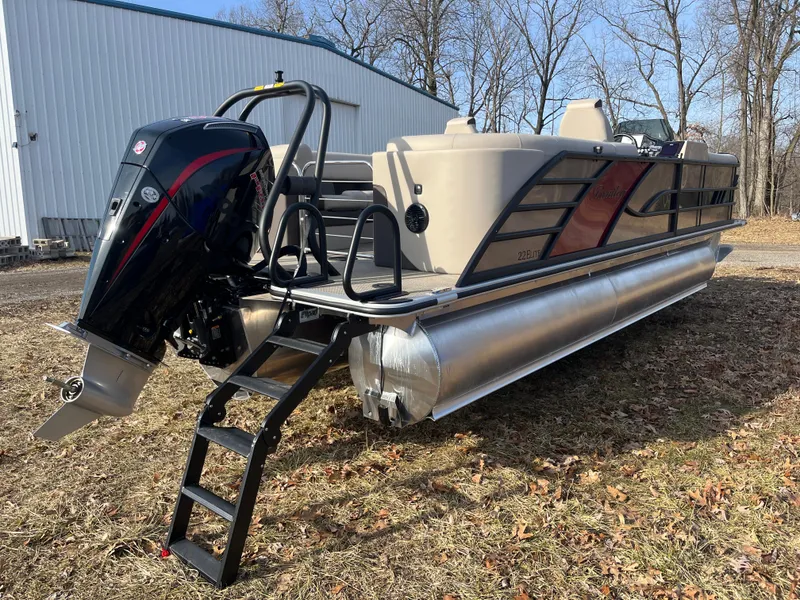 Slide: The Image of 2025 Bentley Pontoons 223 Elite Admiral on grass, featuring sleek design and powerful outboard motor. - 5