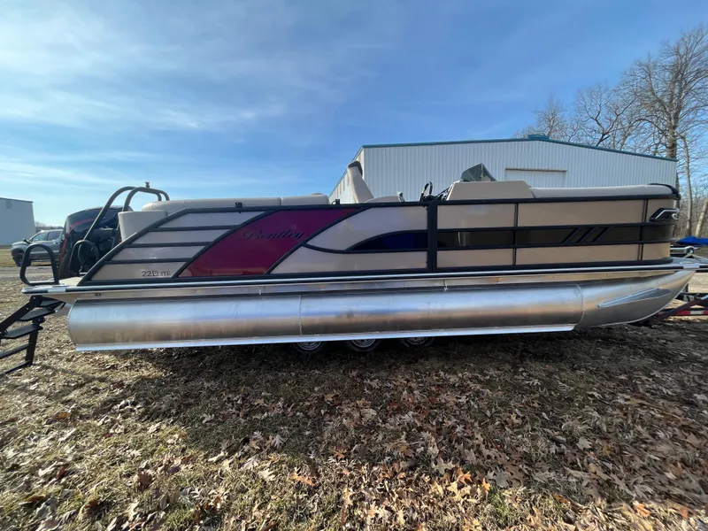 Slide: The Image of 2025 Bentley Pontoons 223 Elite Admiral on grassy area, showcasing sleek design and modern features. - 6