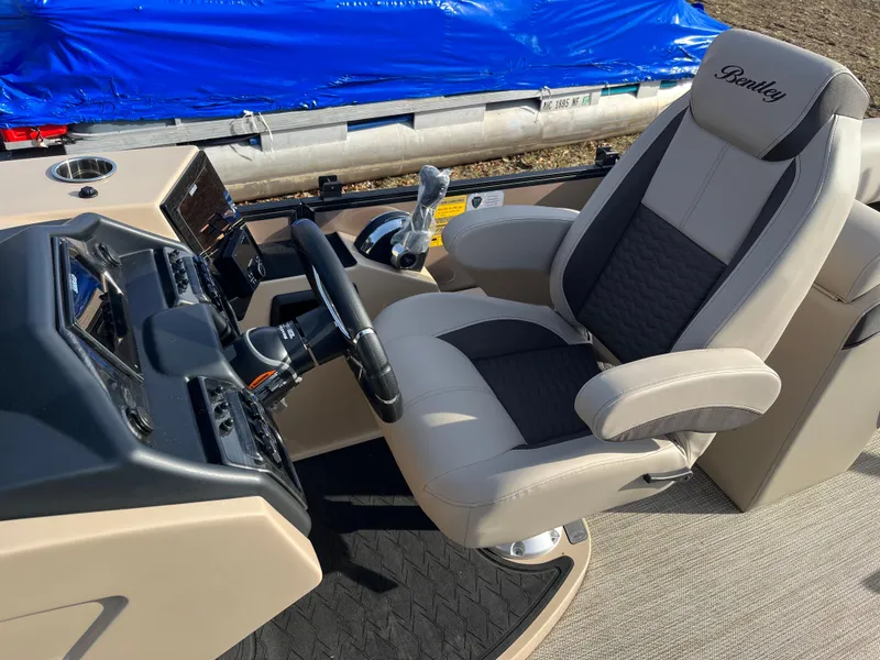 Slide: The Image of 2025 Bentley Pontoons 223 Elite Admiral helm with luxurious captain's chair and control panel. - 9