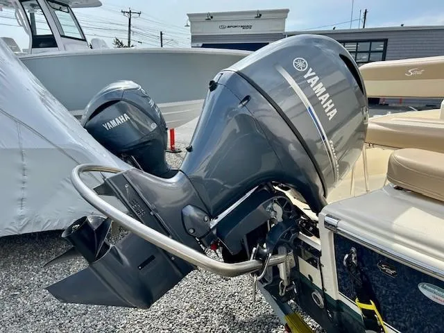 Slide: The Image of 2023 Scout 175 Sportfish with Yamaha outboard motor, parked on gravel. - 14