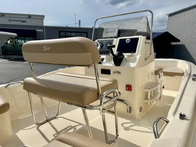 Slide: The Image of 2023 Scout 175 Sportfish boat interior with beige seating and modern console. - 4