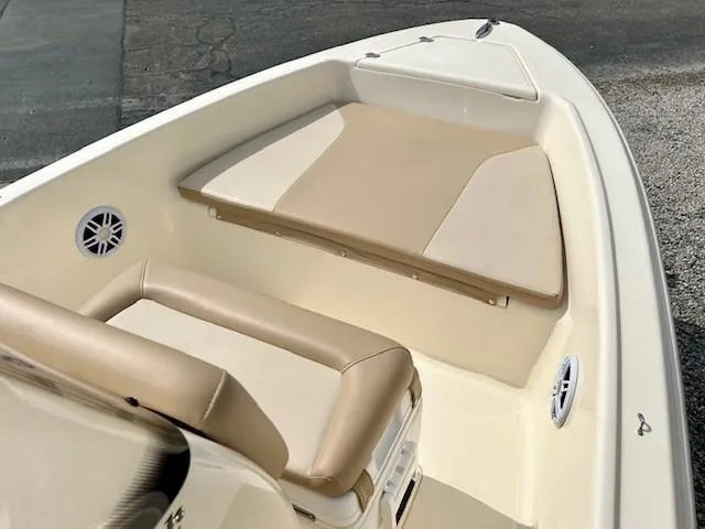 Slide: The Image of 2023 Scout 175 Sportfish boat interior with beige seating and speakers. - 8