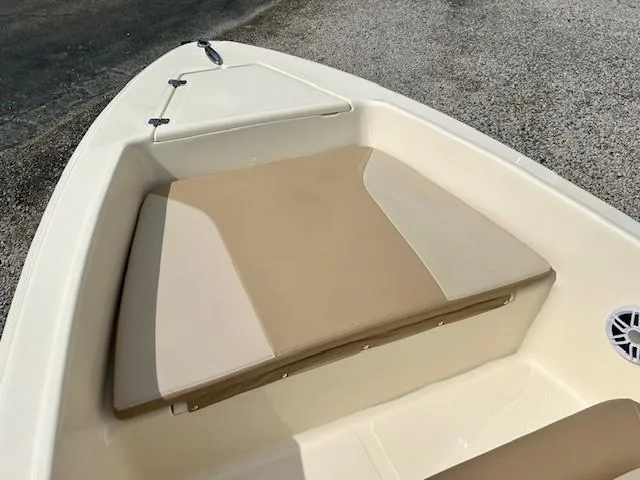 Slide: The Image of 2023 Scout 175 Sportfish boat interior with beige seating and storage compartment. - 9