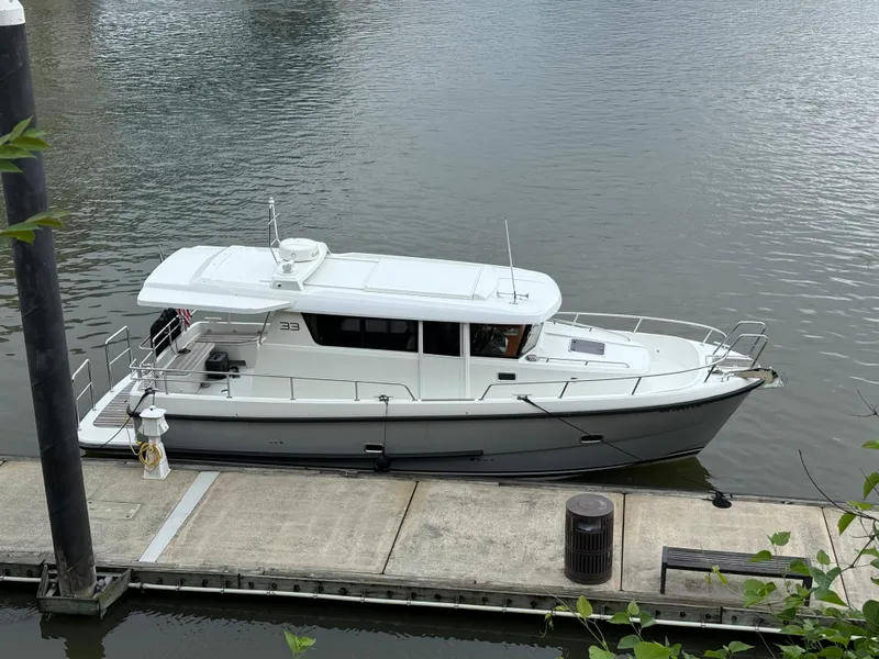 Slide: The Image of 2019 Sargo 33 All Season boat docked on calm water. - 2