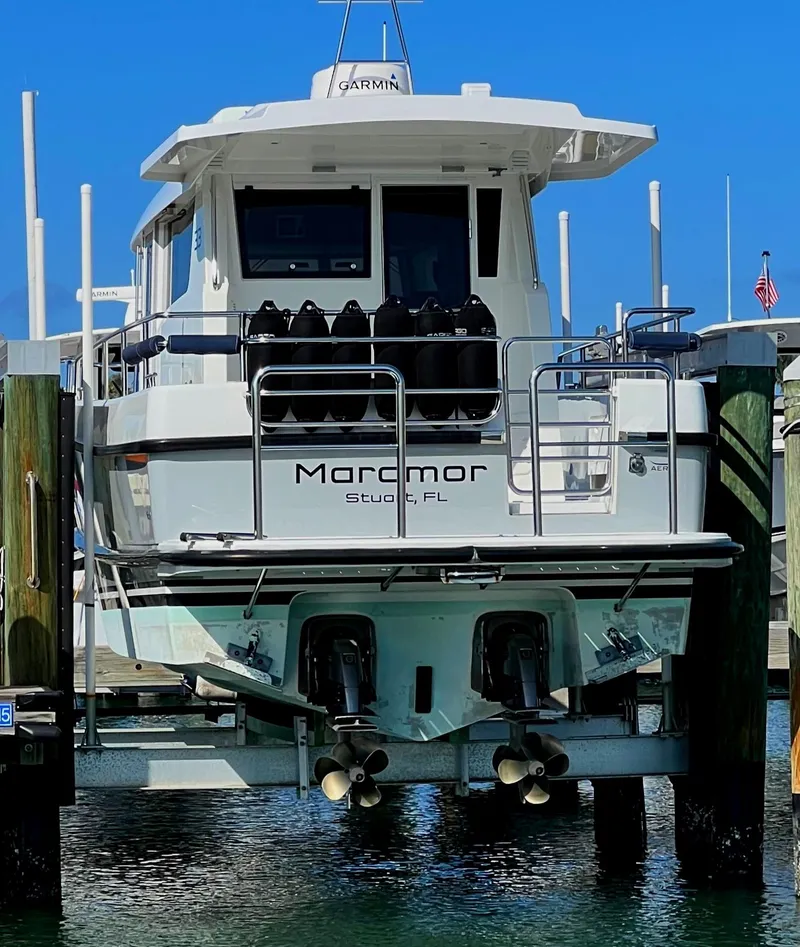 Slide: The Image of 2019 Sargo 33 All Season boat docked, rear view, with dual propellers visible. - 6