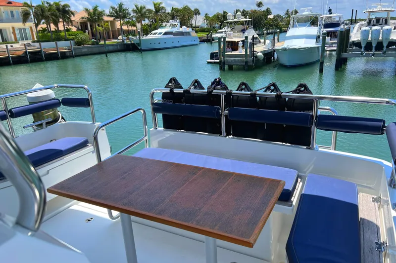 Slide: The Image of 2019 Sargo 33 All Season yacht with outdoor seating and table, docked in a marina. - 7