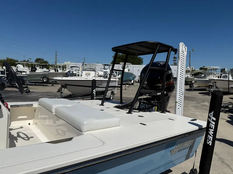 Slide: The Image of 2024 Hewes 18 Redfisher boat in a marina, featuring sleek design and modern amenities. - 6