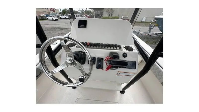 Slide: The Image of 2024 Sea Chaser 23 LX boat console with steering wheel and control panel. - 12