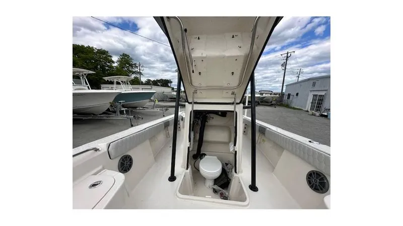 Slide: The Image of 2024 Sea Chaser 23 LX boat interior with open hatch and visible toilet. - 14
