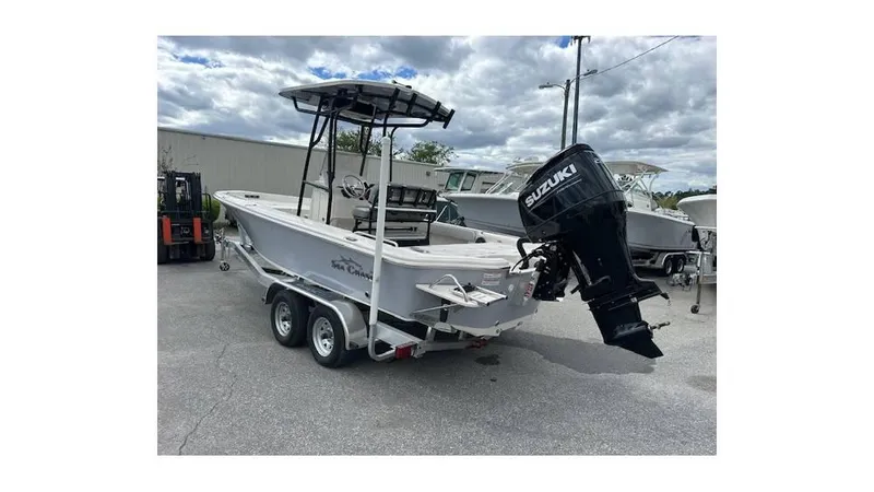 Slide: The Image of 2024 Sea Chaser 23 LX boat on trailer with Suzuki outboard motor. - 2