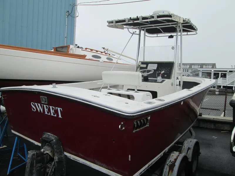 Slide: The Image of 1977 SeaCraft SF 23 IO boat with red hull, docked on a trailer. - 3