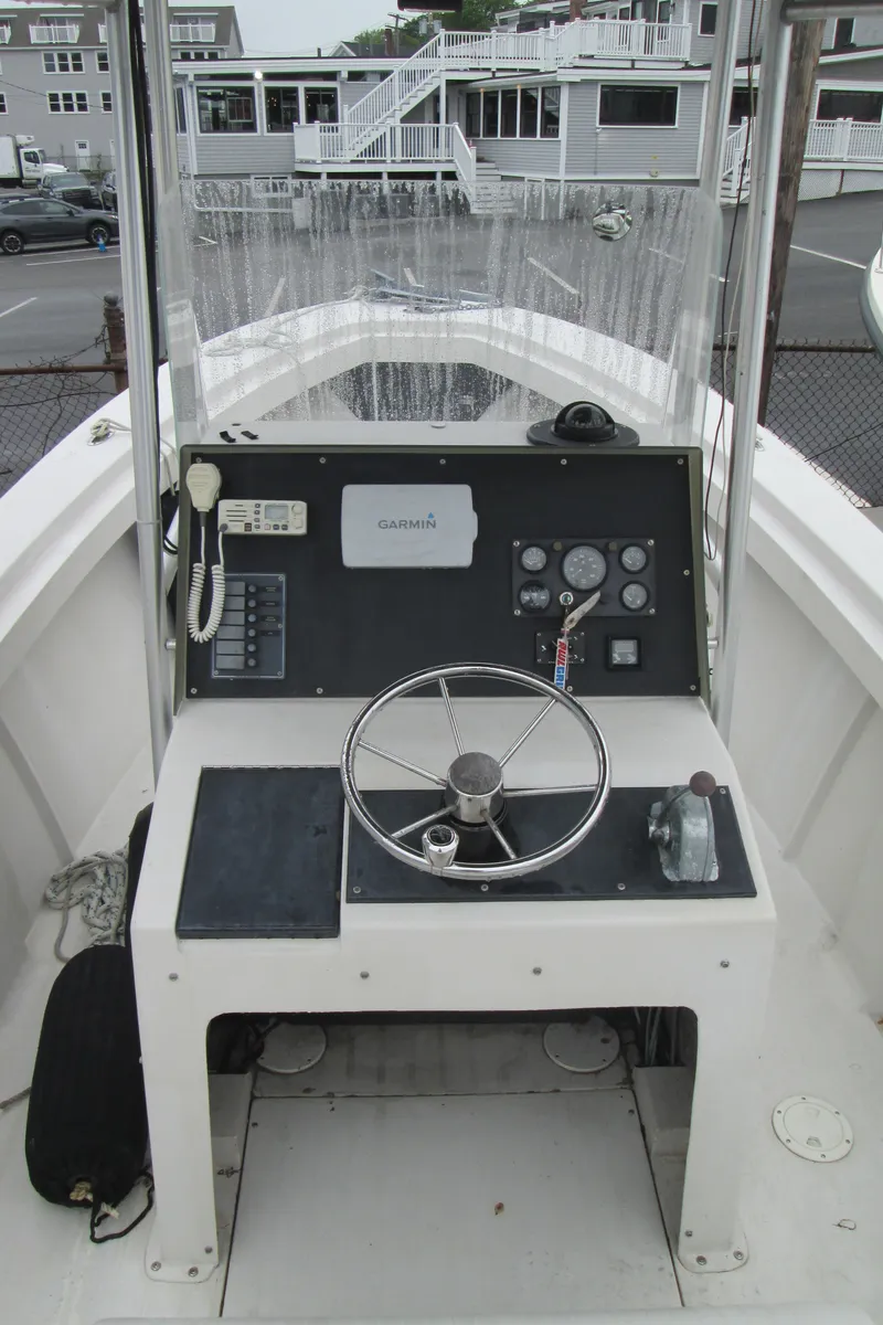 Slide: The Image of 1977 SeaCraft SF 23 IO boat cockpit with steering wheel and control panel. - 6