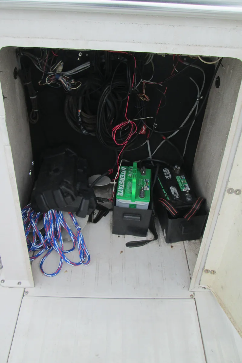Slide: The Image of 1977 SeaCraft SF 23 IO boat wiring and battery compartment with visible cables and batteries. - 7