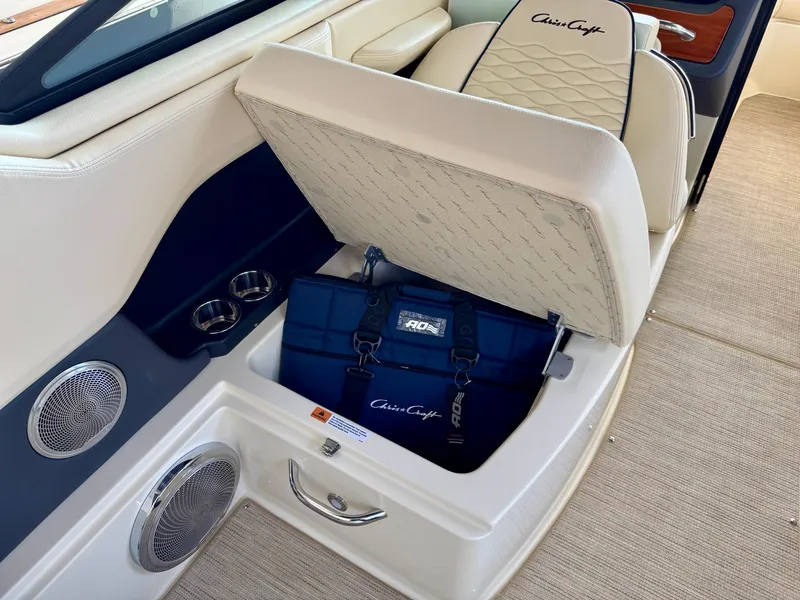 Slide: The Image of 2025 Chris-Craft Sportster 25 boat interior with storage compartment and luxury seating. - 14