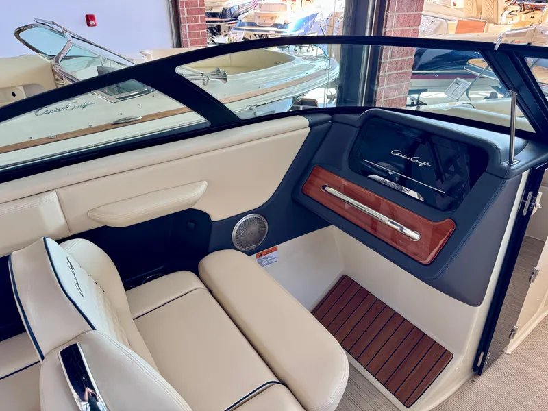 Slide: The Image of 2025 Chris-Craft Sportster 25 interior with luxurious seating and elegant wood accents. - 16