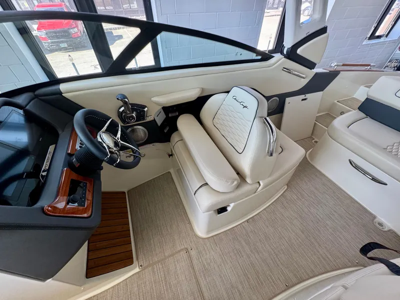 Slide: The Image of Interior of 2025 Chris-Craft Sportster 25 boat, featuring luxurious seating and modern controls. - 17