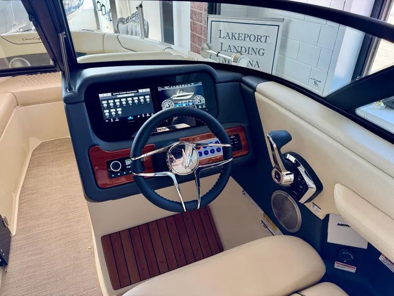 Slide: The Image of 2025 Chris-Craft Sportster 25 boat interior with modern dashboard and steering wheel. - 21