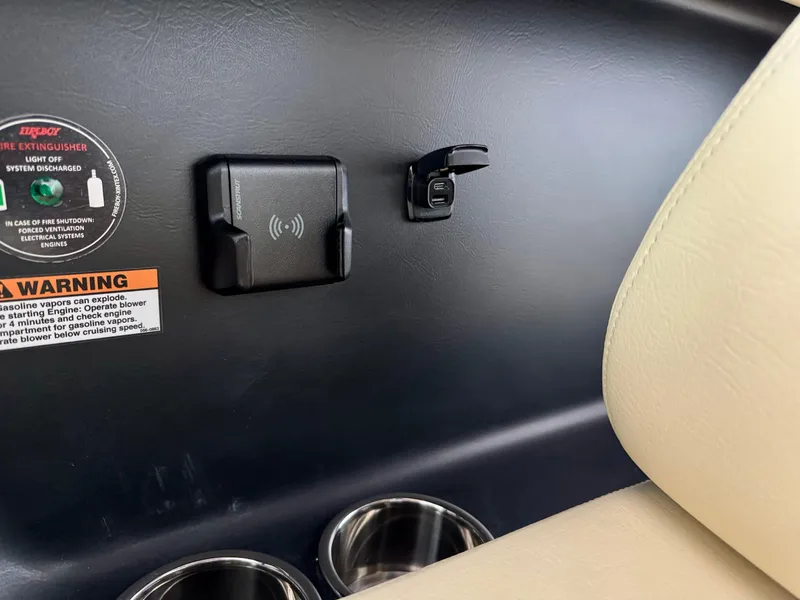 Slide: The Image of Interior of 2025 Chris-Craft Sportster 25 showing cup holders and charging port. - 23