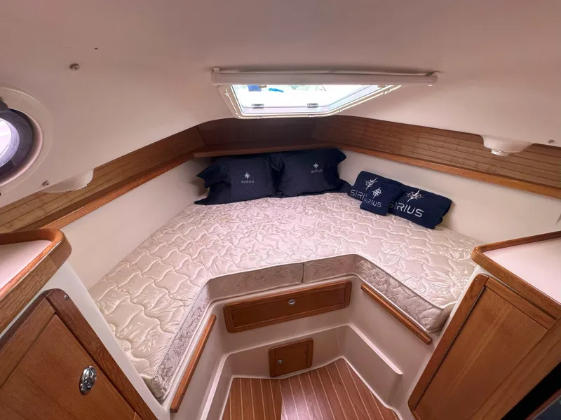 Slide: The Image of 2007 Catalina 34 MkII cabin interior with cozy bed and wooden accents. - 10