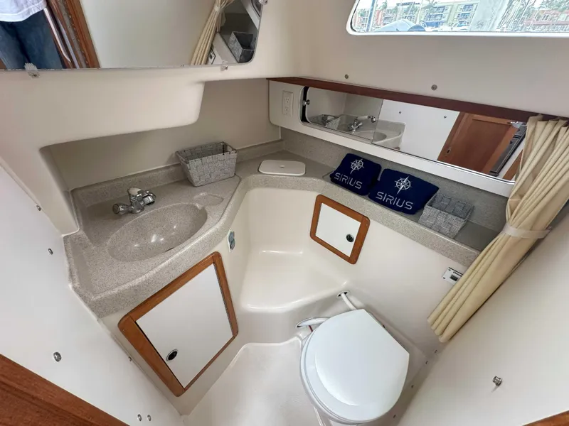 Slide: The Image of 2007 Catalina 34 MkII bathroom with sink, toilet, and storage cabinets. - 15