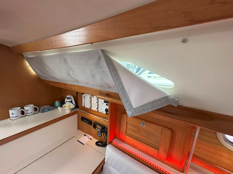 Slide: The Image of Interior of 2007 Catalina 34 MkII sailboat with wooden cabinetry and control panel. - 17