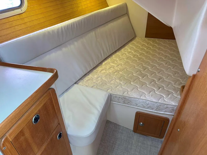 Slide: The Image of 2007 Catalina 34 MkII cabin interior with cushioned seating and wooden cabinetry. - 19
