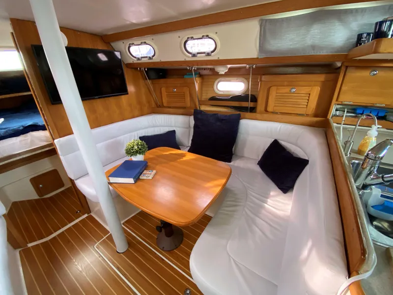Slide: The Image of Interior of 2007 Catalina 34 MkII sailboat with cozy seating and wooden table. - 23