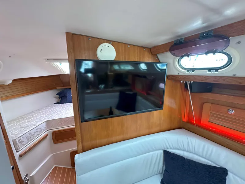 Slide: The Image of Interior of 2007 Catalina 34 MkII yacht with TV, seating, and cozy cabin space. - 24