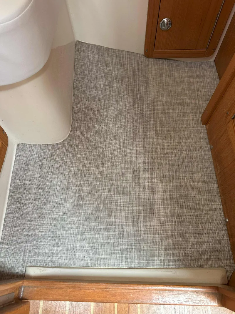 Slide: The Image of Interior of 2007 Catalina 34 MkII with textured flooring and wooden cabinetry. - 9