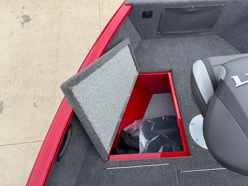 Slide: The Image of 2025 Lund 1650 Rebel XL SS boat interior with open storage compartment. - 14