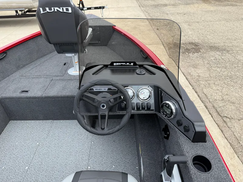 Slide: The Image of 2025 Lund 1650 Rebel XL SS boat interior with steering console and seating. - 15